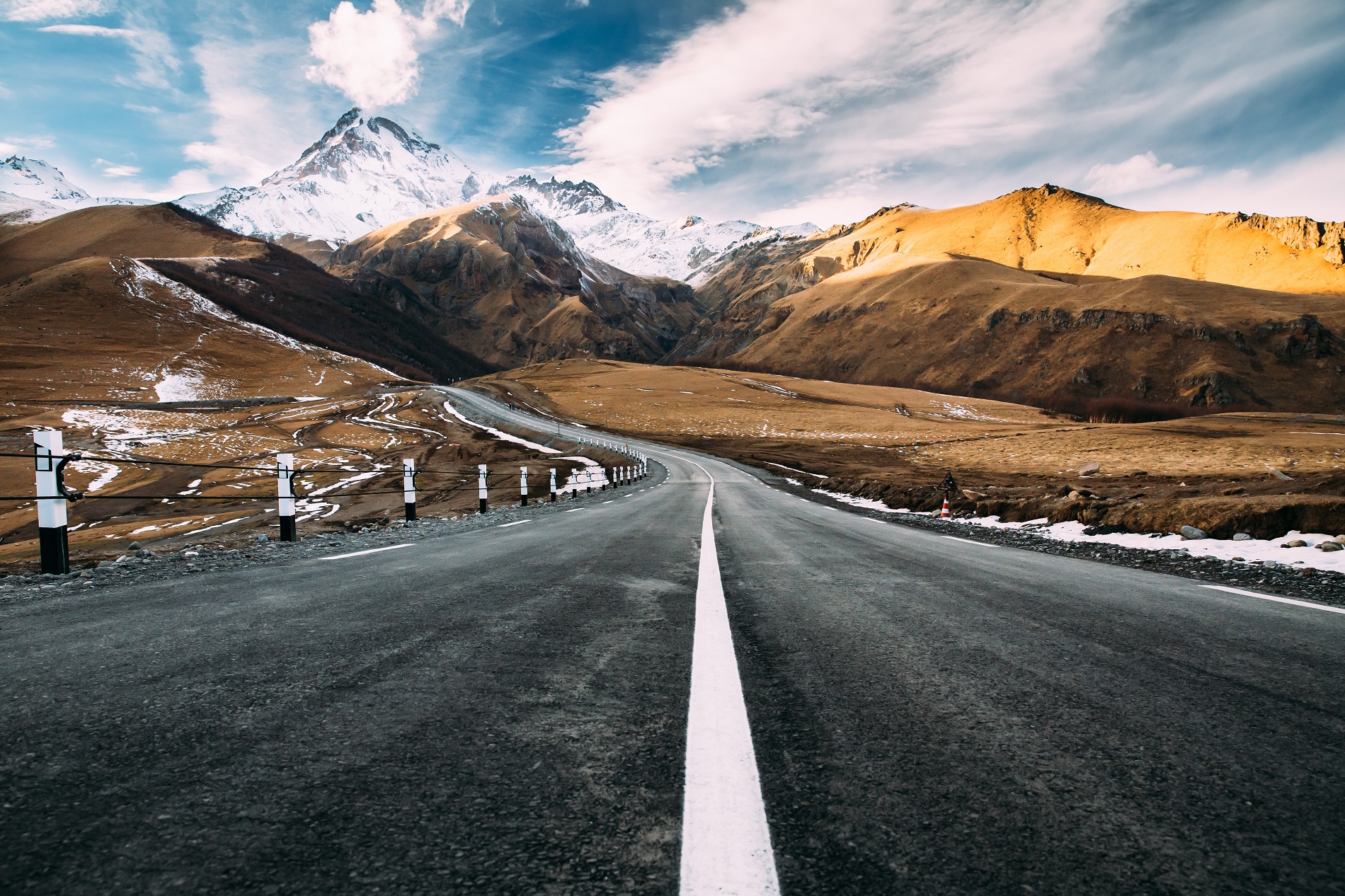 Gergeti, Georgia. Open Road To Peak Of Mount Kazbek In Autumn Season. Kazbek Is A Stratovolcano And One Of Major Mountains Of Caucasus. Beautiful Georgian Nature Landscape In Early Winter.